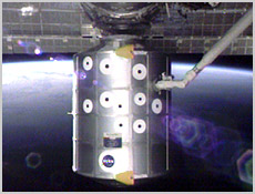 Space Shuttle Endeavour's robotic arm, which is being controlled by STS-100 Mission Specialist Scott Parazynski, moves the Raffaello Multi-Purpose Logistics Module away from the International Space Station. Raffaello was unberthed from the station about 3:03 p.m. CDT (20:03 GMT) Friday. NASA image.