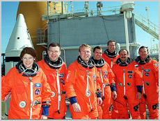 The STS-102 crew poses for a photo on the 215-foot level of the Fixed Service Structure. Standing, left to right, are Susan Helms, James Kelly, Andrew Thomas, Paul Richards, James Wetherbee, Yury Usachev and James Voss. Image courtesy of NASA.