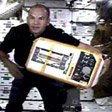 STS-105 Pilot Rick Sturckow moves equipment on the International Space Station. Image courtesy of NASA JSC.