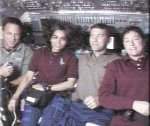 From Columbia's flight deck, the STS-107 red team speaks with reporters on Earth. From left are, Payload Specialist Ilan Ramon, Mission Specialist Kalpana Chawla, Commander Rick Husband and Mission Specialist Laurel Clark. NASA image.