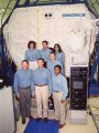 The STS-107 crew in front of the SPACEHAB Research Double Module that will fly aboard Columbia. TOP: Laurel Clark, Ilan Ramon, Kalpana Chawla. MIDDLE: William McCool. BOTTOM: David Brown, Rick Husband, Michael Anderson. Photo courtesy of SPACEHAB, Inc.
