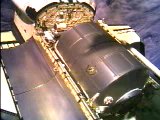 In this exclusive NewsFromSpace shot, the Raffaello cargo module can be seen resting in Endeavour's open payload bay, shortly before the orbiter undocks with Space Station Alpha. Image courtesy of NASA TV.