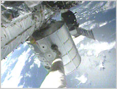 The Shuttle's robotic arm grapples the Raffaello Multi-Purpose Logistics Module. NASA image.