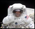 John Grunsfeld offers a hearty thumbs-up to his crewmates near the end of the first space walk.. NASA photo.