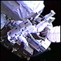 NASA image of Mission Specialist Jerry Ross at the beginning of STS-110's second spacewalk, Astronaut Ross prepares the end of Canadarm2 for Astronaut Lee Morin, who will be attached to the arm. Click for a larger (but slightly different) image.