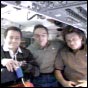 From the shuttle's flight deck, the returning Expedition Four crew talks to journalists on Earth. NASA image.