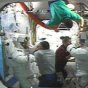 Following the completion of their second spacewalk, STS-112 Mission Specialists Piers Sellers, far left, and David Wolf, far right, receive assistance getting out of their spacesuits in the Quest Airlock. STS-112 Mission Specialists Fyodor Yurchikhin assists Sellers, and STS-112 Pilot Pam Melroy and Expedition Five Commander Valery Korzun, at top, assist Wolf. NASA image.