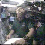 STS-112 Mission Specialist Piers Sellers reviews a procedure on Atlantis' flight deck Wednesday. NASA image.