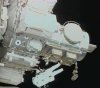In this NASA TV capture, STS-112 Mission Specialist David Wolf works outside the International Space Station's Qwest airlock.