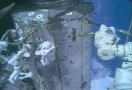 STS-112 astronauts Wolf (left, with stripes on legs) and Sellers (right) working outside the ISS. NASA TV capture.