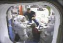 Cosmonsaut Fyodor Yurchikhin (top) and Pilot Pam Melroy assist Piers Sellers (left) and Dave Wolf (right) shortly after EVA #3. NASA TV capture.