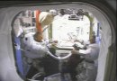 Piers Sellers (left) and Dave Wolf are all smiles after EVA #3. They are being helped off with their spacesuits by STS-112 Mission Specialist Fyodor Yurchikhin (left) and Pilot Pam Melroy (right). NASA TV capture.