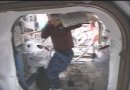 'Ha ha, very funny, you guys! The old empty-spacesuit trick!' OK, we're just making that up Pam Melroy is NOT searching for spacewalkers Selers and Wolf. That's a bit of ISS Commander Valery Korzun's green shirt you see in the background. NASA TV capture.