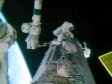 NASA TV capture of spacewalkers David Wolf and Piers Sellers working outside the ISS.