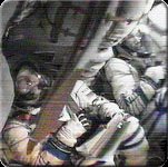 Cosmonauts Yuri Gidzenko and Sergei Krikalev (far right) are viewed in the Soyuz capsule during ascent into orbit. Just out of sight is American astronaut Bill Shepherd. Image courtesy of NASA/RSA.