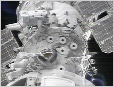 Space walkers Ed Lu and Yuri Malenchenko work outside of the Zvezda Service Module. They are tethered to the space station about 40 meters (130 feet) above Atlantis' payload bay. Photo courtesy NASA.