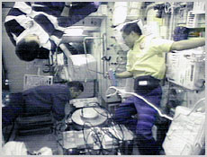 Clockwise from the top, STS-106 Pilot Scott Altman, Mission Specialist Ed Lu and Mission Specialist Boris Morukov install a treadmill in the Zvezda Service Module. Image coutesy of NASA.