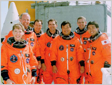 The STS-92 crew poses for a photo at Launch Pad 39A at Kennedy Space Center, Fla. Standing, left to right, are Pilot Pamela Ann Melroy, Commander Brian Duffy and Mission Specialists Michael Lopez-Alegria, Peter J.K."Jeff" Wisoff, Leroy Chiao, William S. McArthur Jr. and Koichi Wakata. Photo courtesy of NASA.