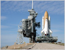 At the top of the incline to Launch Pad 39A, Space Shuttle Atlantis nears the Rotating Service Structure (left). Photo courtesy of NASA.
