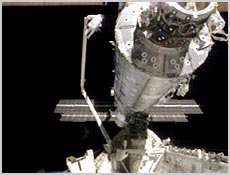 Astronaut Thomas Jones rides Space Shuttle Atlantis' robotic arm on Monday during the second of three scheduled space walks during STS-98. The arm was operated by STS-98 Astronaut Marsha Ivins. NASA image.