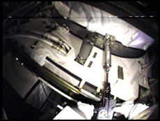 This a view from the helmet camera that STS-98 Mission Specialist Tom Jones is wearing as he uses a tool to unbolt Pressurized Mating Adapter 2 from the Z1 Truss during the mission's second space walk. NASA image
